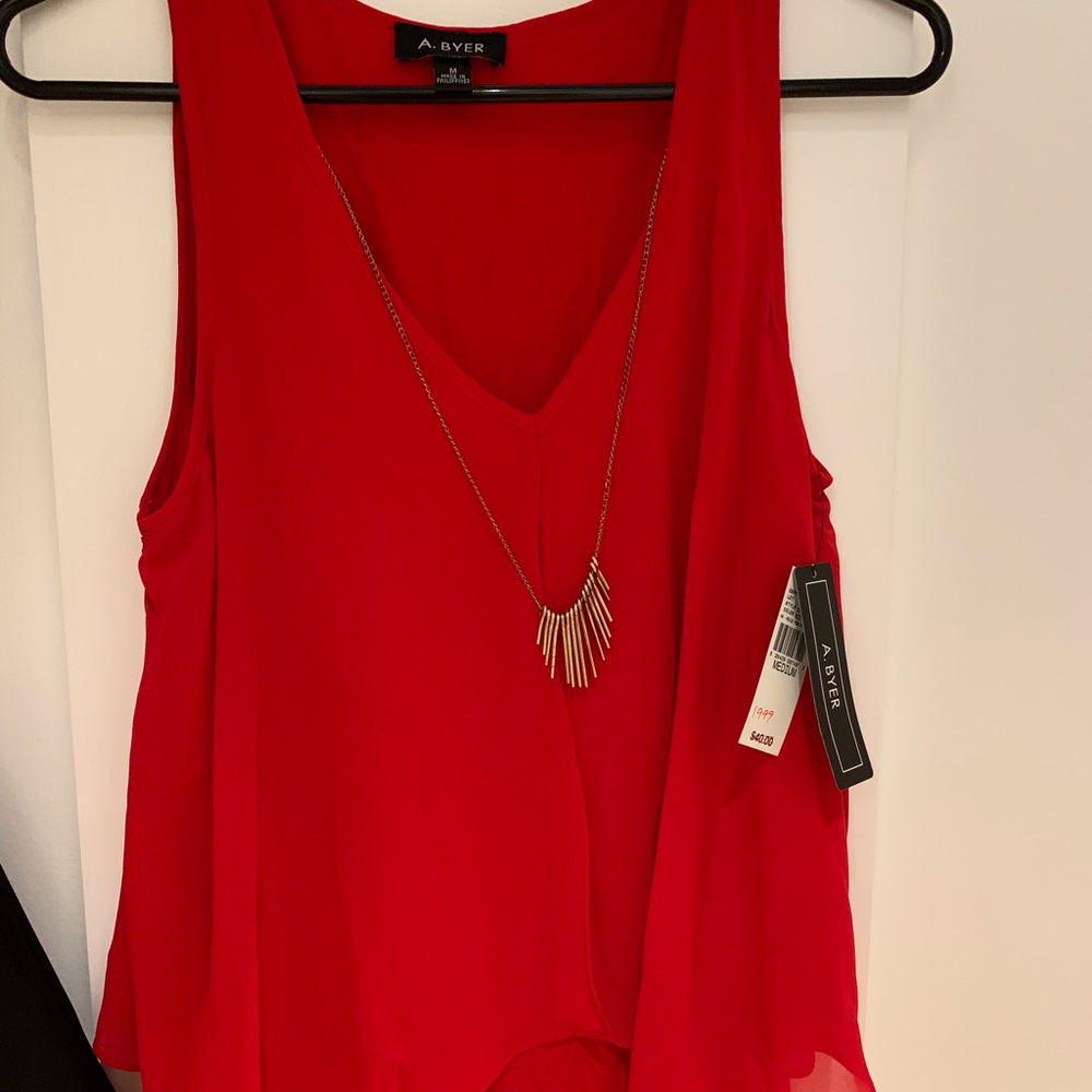 Red blouse with necklace attached.
